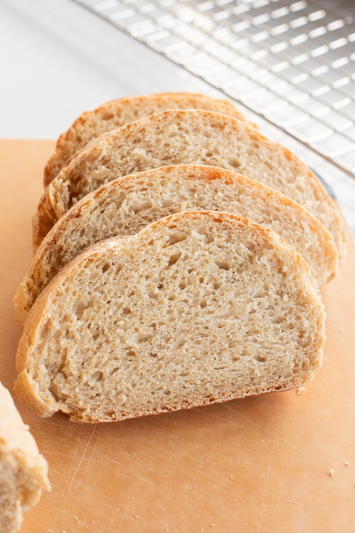 fresh milled flour french bread slices on cutting board.