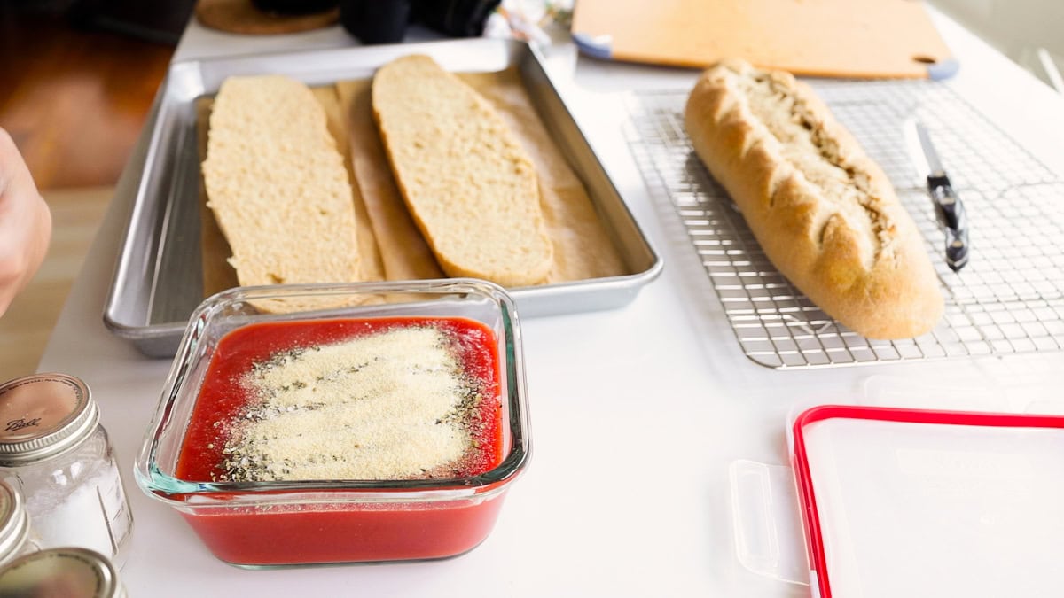 making homemade pizza sauce in a glass container.