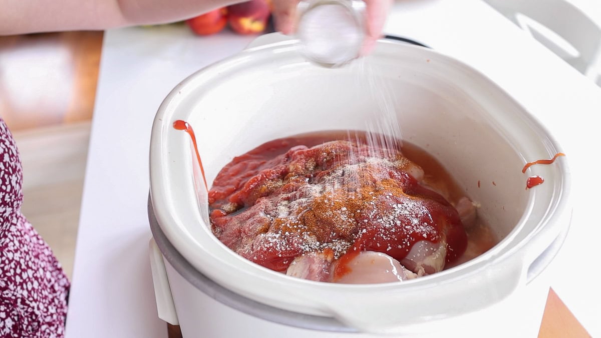 pouring salt into slow cooker.