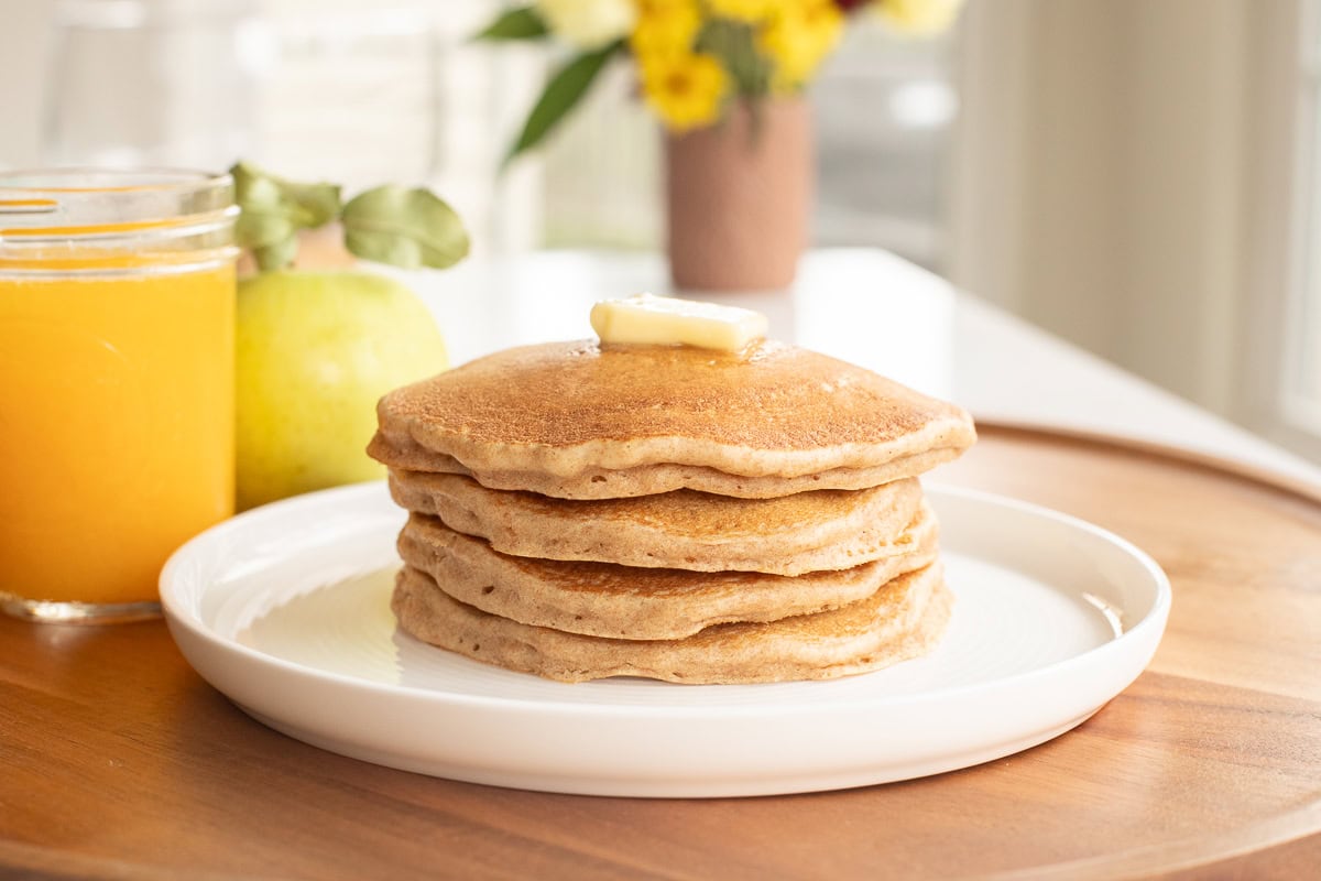 stack of spelt pancakes with a pat of butter.