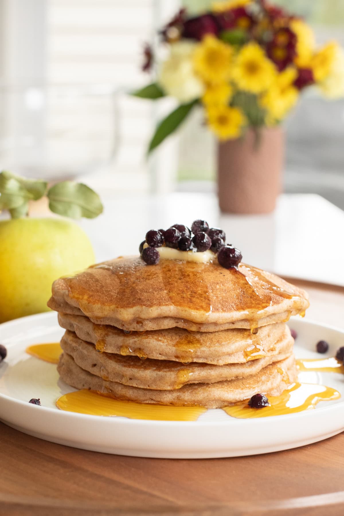 spelt pancakes stacked on a plate.